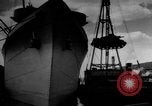 Image of Silhouettes of U.S. Army soldiers boarding a troop transport ship. Pacific Theater, 1942, second 21 stock footage video 65675071824