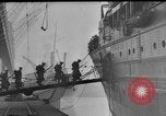 Image of Silhouettes of U.S. Army soldiers boarding a troop transport ship. Pacific Theater, 1942, second 28 stock footage video 65675071824