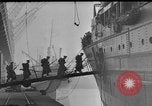 Image of Silhouettes of U.S. Army soldiers boarding a troop transport ship. Pacific Theater, 1942, second 29 stock footage video 65675071824