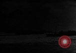 Image of Silhouettes of U.S. Army soldiers boarding a troop transport ship. Pacific Theater, 1942, second 40 stock footage video 65675071824
