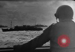 Image of Silhouettes of U.S. Army soldiers boarding a troop transport ship. Pacific Theater, 1942, second 45 stock footage video 65675071824