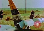 Image of German farmers work aroung a crashed U.S. Air Force P-47 in a field Germany, 1945, second 12 stock footage video 65675072706