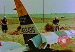 Image of German farmers work aroung a crashed U.S. Air Force P-47 in a field Germany, 1945, second 13 stock footage video 65675072706