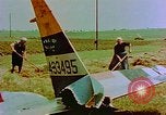 Image of German farmers work aroung a crashed U.S. Air Force P-47 in a field Germany, 1945, second 14 stock footage video 65675072706