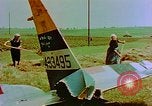 Image of German farmers work aroung a crashed U.S. Air Force P-47 in a field Germany, 1945, second 15 stock footage video 65675072706