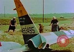 Image of German farmers work aroung a crashed U.S. Air Force P-47 in a field Germany, 1945, second 16 stock footage video 65675072706