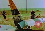 Image of German farmers work aroung a crashed U.S. Air Force P-47 in a field Germany, 1945, second 18 stock footage video 65675072706