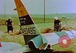 Image of German farmers work aroung a crashed U.S. Air Force P-47 in a field Germany, 1945, second 21 stock footage video 65675072706