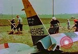 Image of German farmers work aroung a crashed U.S. Air Force P-47 in a field Germany, 1945, second 26 stock footage video 65675072706