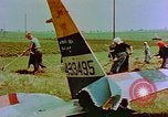 Image of German farmers work aroung a crashed U.S. Air Force P-47 in a field Germany, 1945, second 27 stock footage video 65675072706