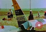 Image of German farmers work aroung a crashed U.S. Air Force P-47 in a field Germany, 1945, second 30 stock footage video 65675072706