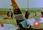 Image of German farmers work aroung a crashed U.S. Air Force P-47 in a field Germany, 1945, second 31 stock footage video 65675072706