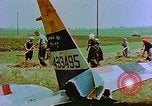 Image of German farmers work aroung a crashed U.S. Air Force P-47 in a field Germany, 1945, second 32 stock footage video 65675072706