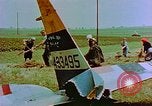 Image of German farmers work aroung a crashed U.S. Air Force P-47 in a field Germany, 1945, second 33 stock footage video 65675072706