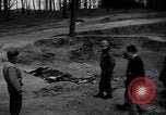 Image of unburied bodies of victims Germany, 1945, second 3 stock footage video 65675073912