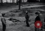 Image of unburied bodies of victims Germany, 1945, second 4 stock footage video 65675073912