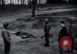 Image of unburied bodies of victims Germany, 1945, second 5 stock footage video 65675073912