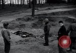 Image of unburied bodies of victims Germany, 1945, second 6 stock footage video 65675073912