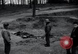 Image of unburied bodies of victims Germany, 1945, second 7 stock footage video 65675073912