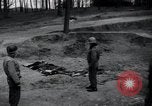 Image of unburied bodies of victims Germany, 1945, second 8 stock footage video 65675073912