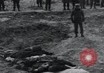 Image of unburied bodies of victims Germany, 1945, second 28 stock footage video 65675073912