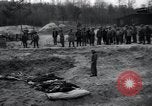 Image of unburied bodies of victims Germany, 1945, second 59 stock footage video 65675073912