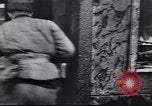 Image of Soviet soldier with  PPSh sub machine gun pulls German soldier from cellar Berlin Germany, 1945, second 3 stock footage video 65675074103