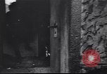 Image of Soviet soldier with  PPSh sub machine gun pulls German soldier from cellar Berlin Germany, 1945, second 5 stock footage video 65675074103