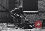 Image of Soviet soldier with  PPSh sub machine gun pulls German soldier from cellar Berlin Germany, 1945, second 7 stock footage video 65675074103