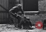 Image of Soviet soldier with  PPSh sub machine gun pulls German soldier from cellar Berlin Germany, 1945, second 8 stock footage video 65675074103