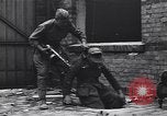 Image of Soviet soldier with  PPSh sub machine gun pulls German soldier from cellar Berlin Germany, 1945, second 9 stock footage video 65675074103