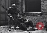 Image of Soviet soldier with  PPSh sub machine gun pulls German soldier from cellar Berlin Germany, 1945, second 10 stock footage video 65675074103