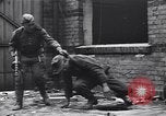 Image of Soviet soldier with  PPSh sub machine gun pulls German soldier from cellar Berlin Germany, 1945, second 11 stock footage video 65675074103
