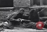 Image of Soviet soldier with  PPSh sub machine gun pulls German soldier from cellar Berlin Germany, 1945, second 13 stock footage video 65675074103