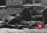 Image of Soviet soldier with  PPSh sub machine gun pulls German soldier from cellar Berlin Germany, 1945, second 15 stock footage video 65675074103