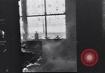 Image of Soviet soldier with  PPSh sub machine gun pulls German soldier from cellar Berlin Germany, 1945, second 16 stock footage video 65675074103
