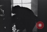 Image of Soviet soldier with  PPSh sub machine gun pulls German soldier from cellar Berlin Germany, 1945, second 17 stock footage video 65675074103