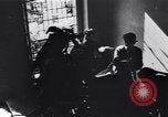 Image of Soviet soldier with  PPSh sub machine gun pulls German soldier from cellar Berlin Germany, 1945, second 20 stock footage video 65675074103