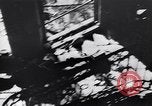 Image of Soviet soldier with  PPSh sub machine gun pulls German soldier from cellar Berlin Germany, 1945, second 22 stock footage video 65675074103