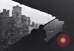 Image of Soviet soldier with  PPSh sub machine gun pulls German soldier from cellar Berlin Germany, 1945, second 25 stock footage video 65675074103