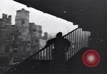 Image of Soviet soldier with  PPSh sub machine gun pulls German soldier from cellar Berlin Germany, 1945, second 26 stock footage video 65675074103