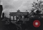 Image of Soviet soldier with  PPSh sub machine gun pulls German soldier from cellar Berlin Germany, 1945, second 32 stock footage video 65675074103
