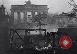 Image of Soviet soldier with  PPSh sub machine gun pulls German soldier from cellar Berlin Germany, 1945, second 57 stock footage video 65675074103