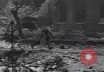 Image of Soviet soldier with  PPSh sub machine gun pulls German soldier from cellar Berlin Germany, 1945, second 62 stock footage video 65675074103