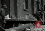 Image of U.S. Army patrol moves carefully through ruins of German City Ludwigshafen Germany, 1945, second 10 stock footage video 65675074328