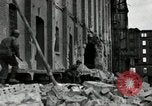 Image of U.S. Army patrol moves carefully through ruins of German City Ludwigshafen Germany, 1945, second 19 stock footage video 65675074328