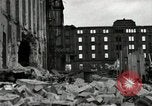 Image of U.S. Army patrol moves carefully through ruins of German City Ludwigshafen Germany, 1945, second 33 stock footage video 65675074328