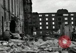 Image of U.S. Army patrol moves carefully through ruins of German City Ludwigshafen Germany, 1945, second 39 stock footage video 65675074328