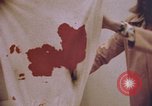 Image of blood stained clothing United States USA, 1969, second 4 stock footage video 65675075429