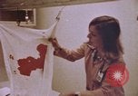 Image of blood stained clothing United States USA, 1969, second 6 stock footage video 65675075429